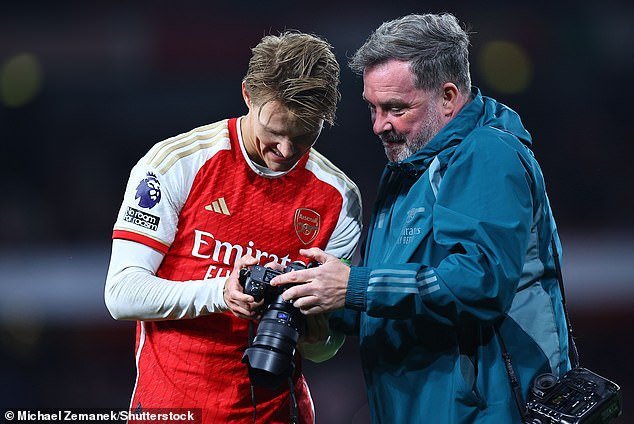 The captain celebrated with a club photographer, but Carragher was not happy with Arsenal's jubilant response