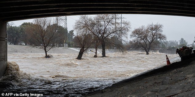 Roads turned into rivers in parts of Los Angeles and San Diego and officials warned residents not to drive to work Tuesday morning
