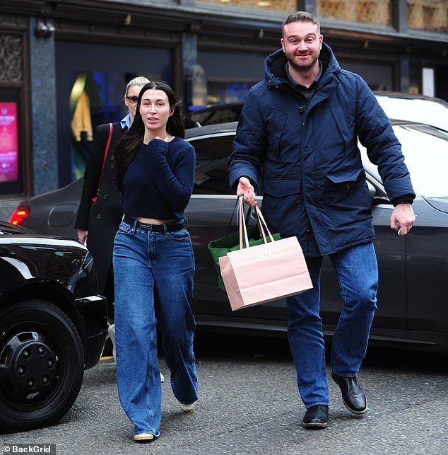 The Russian oligarch's 32-year-old daughter was seen with a male companion by her side, dutifully carrying her shopping bags