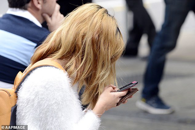 Frustrated customers complain on social media that they can't make calls (photo of woman using her phone)