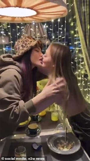 Vlada and Vika kiss each other.  They were hunted by police and also risk high fines for flouting laws banning LGBT propaganda