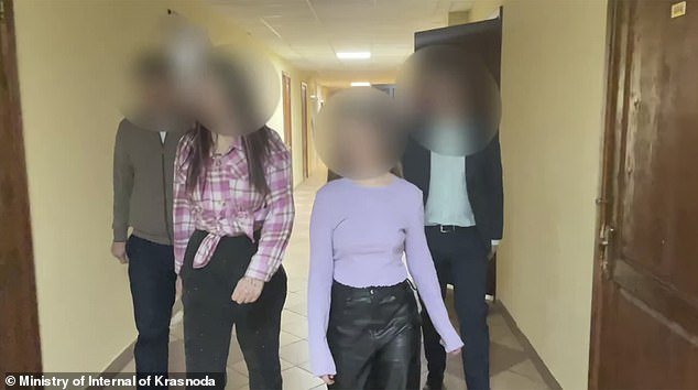 Vlada and Vika are taken away by the police.  The pair were told by police they could 'damage the psyche' of minors who viewed their video under draconian new laws