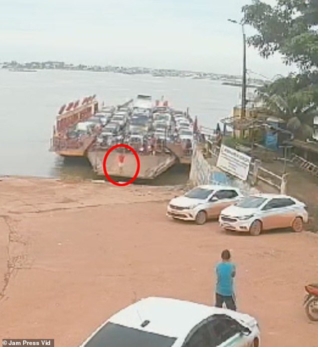 The horrific moment was captured on CCTV footage and shows the man jumping over the fence separating the cars from the driveway as the boat approached the harbour.