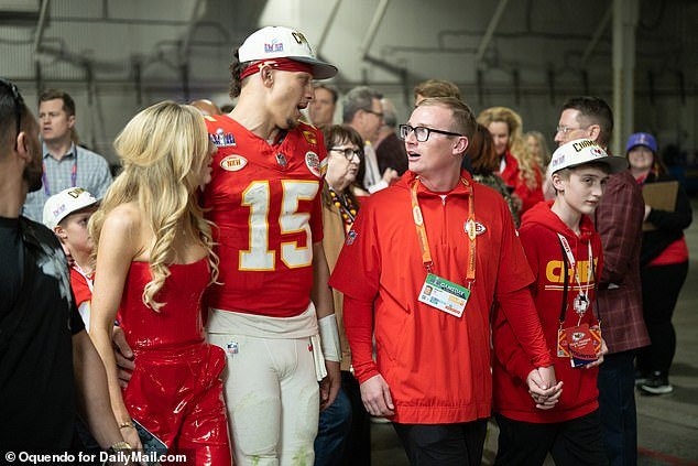 Chiefs quarterback Patrick Mahomes leaves the field after an all-time great performance with his wife Brittany