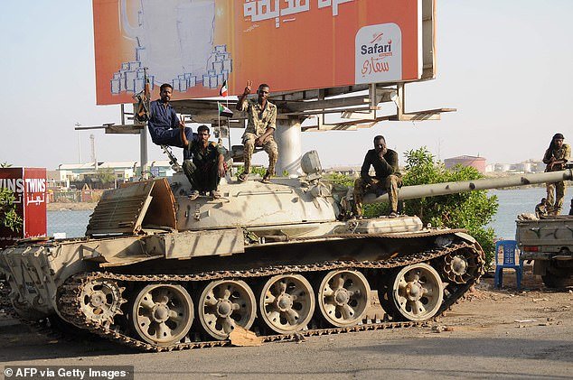 Sudanese soldiers loyal to army chief Abdel Fattah al-Burhan sit atop a tank in the Red Sea city of Port Sudan