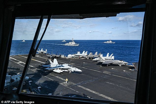 Fighter jets and ships are seen from the bridge of the aircraft carrier USS Carl Vinson during a three-day maritime exercise between the US and Japan in the Philippine Sea on January 31, 2024