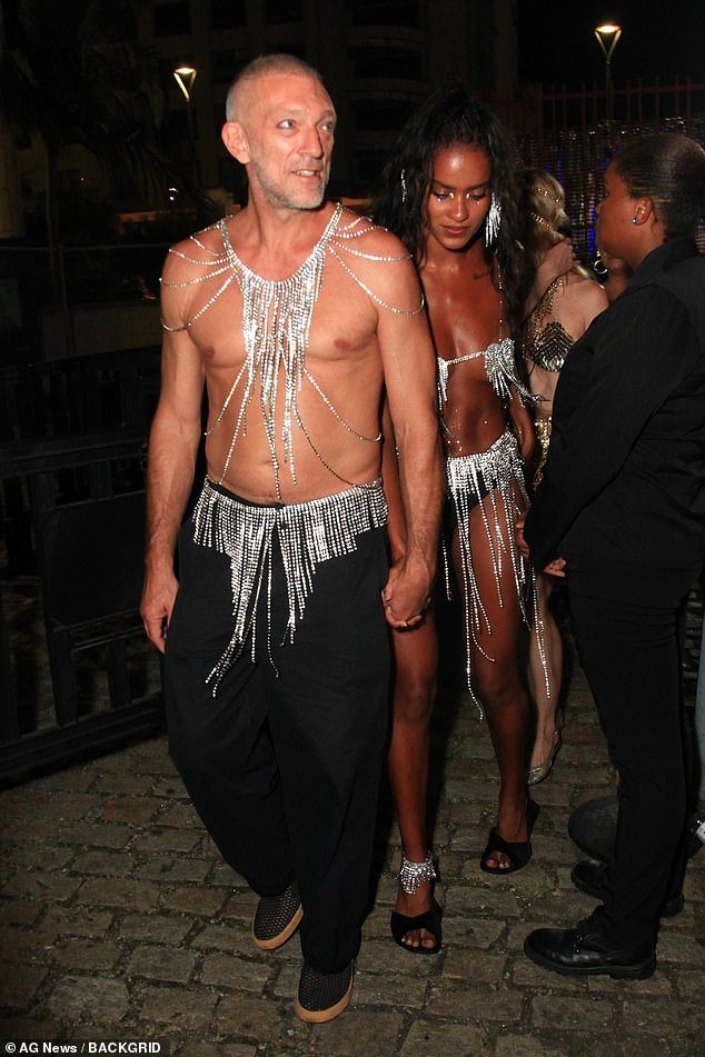 The French actor, 57, stripped naked and wore silver body accessories during the Baile da Arara, which took place in Brazil as part of the festivities