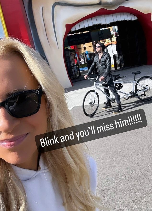 In an image posted online, the radio host, 43, was all smiles as she posed for a selfie outside the theme park with a man dead ringing the blink-182 drummer, 48, in the background.