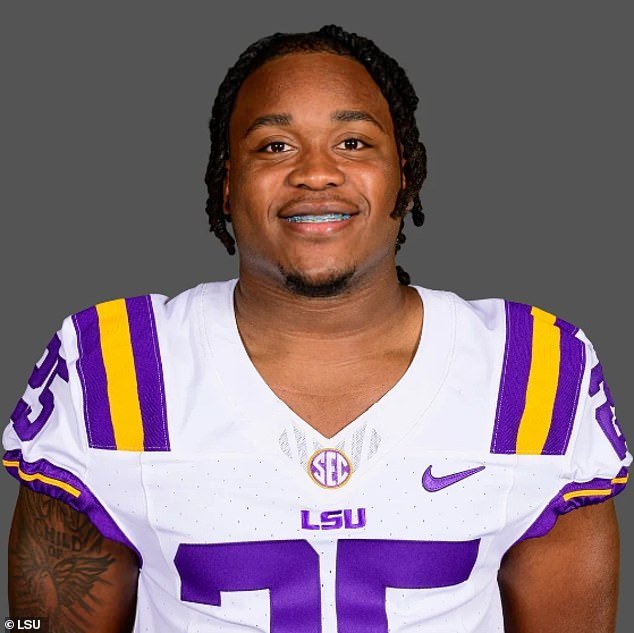 Holly, who plays running back for LSU, was taken into custody on three charges