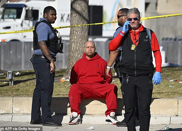 A man wearing a red tracksuit was quickly taken into custody after the shooting, although it is unclear whether he was involved in the tragedy