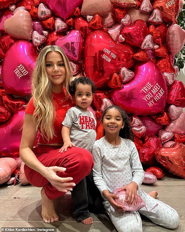 Khloe added a few other photos from Valentine's Day, including a photo of herself wearing a red ensemble as she posed with her two children in front of a wall full of heart-shaped balloons.