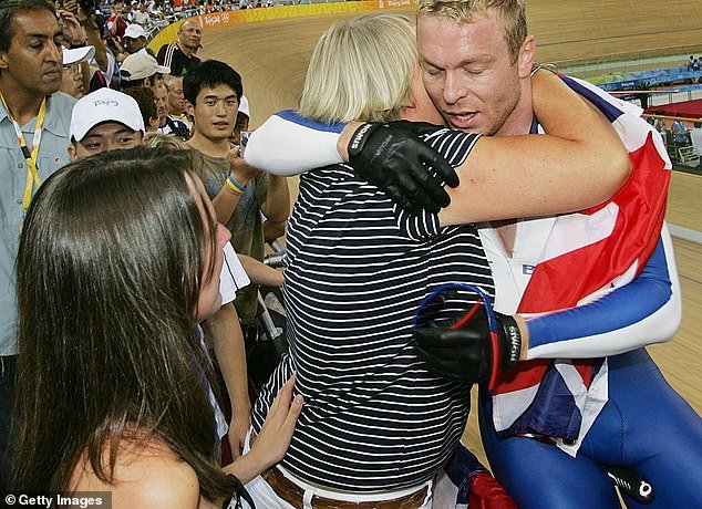 The Olympic legend hugs his mother Carol after she won gold in the individual sprint at the 2008 Beijing Olympics