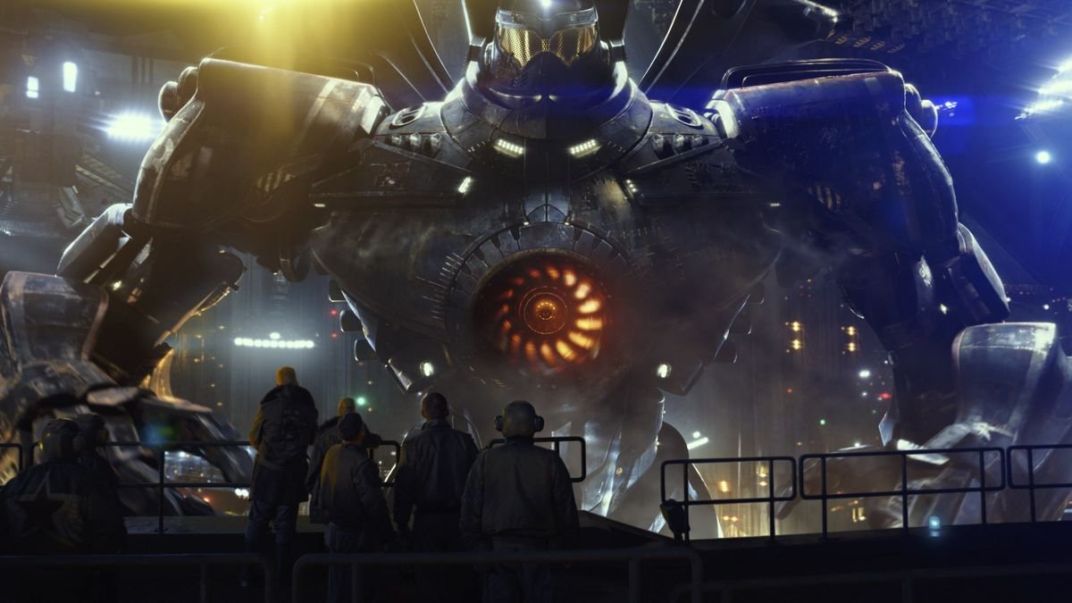 A wide shot of a giant mech being repaired by a team of maintenance workers staring at it in amazement.