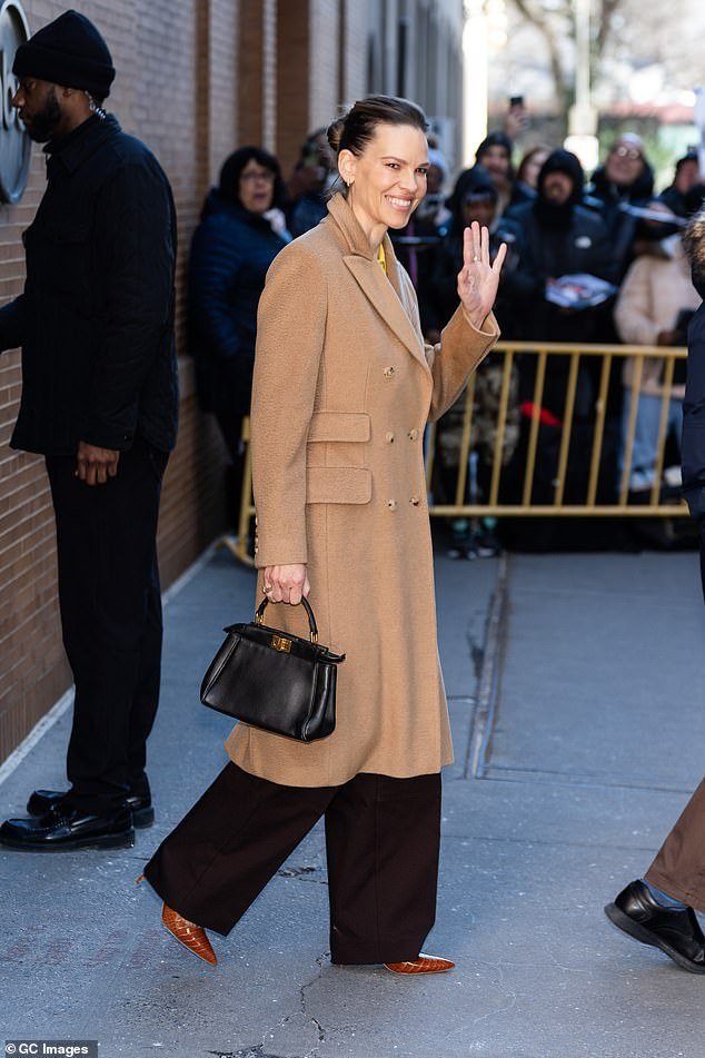 Swank was pictured waving to fans as she was photographed on New York's Upper West Side on Tuesday