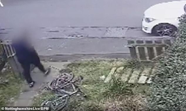The thief glances at the bicycle after delivering the package