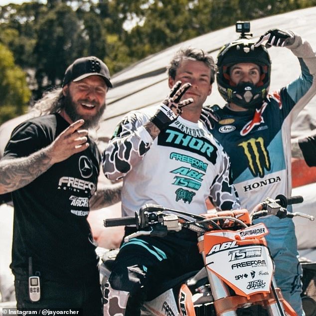 The 27-year-old (pictured center with fellow motocross racers) was practicing the triple backflip that made him famous when he died