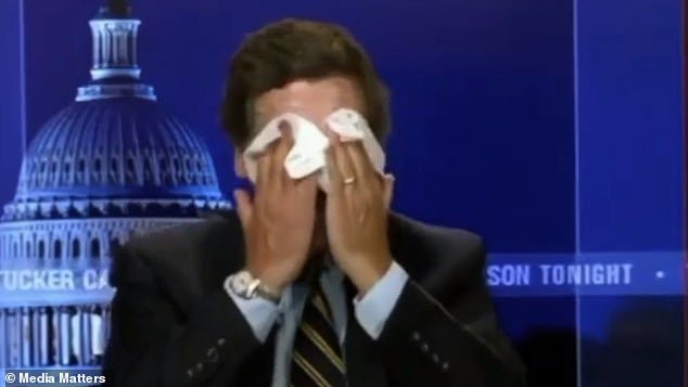 Carlson wipes makeup off his face in a still from one of the videos shared online by Media Matters for America