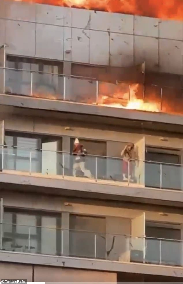 Dramatic images show two residents desperately trying to take shelter from the fire.  The fire brigade rescued a number of people from their balconies