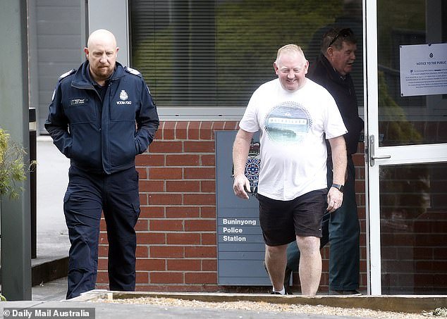 Police said Mick Murphy (pictured leaving a police station on February 9) was not an official suspect but was a 'person of interest' in the investigation