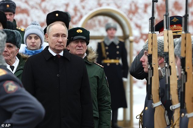 Vladimir Putin takes part in a wreath-laying ceremony at the Tomb of the Unknown Soldier