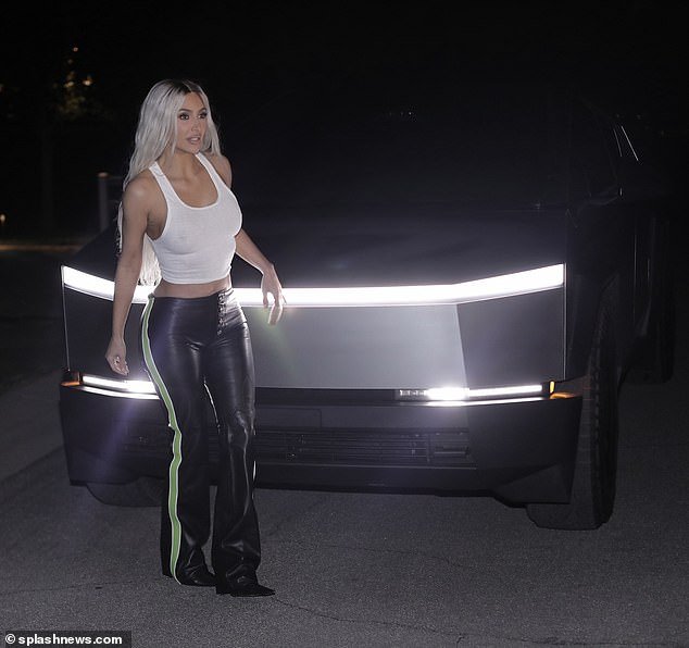 Her chic bootcut pants had a pop of color, while green stripes adorned the sides.  The Kardashians star paired the ensemble with a pair of pointed-toe boots and heels