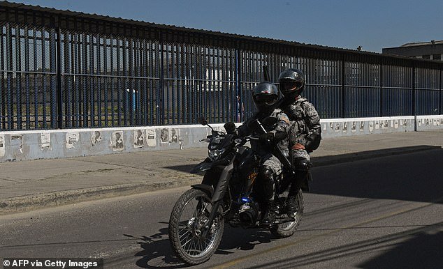 The TV star had already filmed one episode of the series in Colombia, but it might never see the light of day.  Pictured: Two prison guards ride a motorcycle outside La Modelo prison in Bogota, Colombia, on January 25