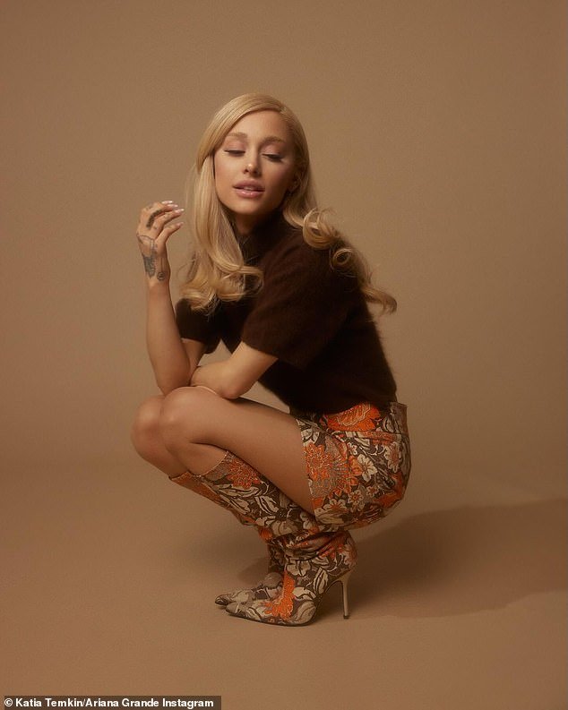 Grande, who captioned the post Eternal Sunshine after the album's name, wore an espresso brown colored velvet turtleneck top, an orange/brown floral print mini skirt and matching knee-high stiletto boots