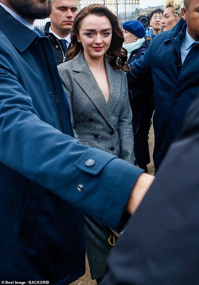 She was flanked by bodyguards as she made her way to the Christian Dior Fall/Winter 2024-2025 ready-to-wear collection