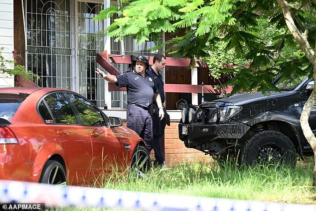 Police have been seen taking bags of evidence from the scene where the two were found dead