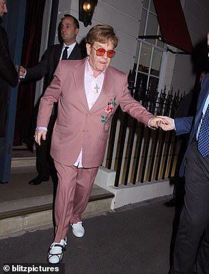 Stepping out, he looked as stylish as ever in a pink suit and shirt and trendy tinted glasses