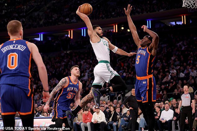 Celtics forward Jayson Tatum drives to the basket against Knicks forward Precious Achiuwa
