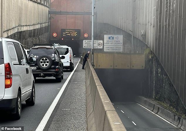 The car fire caused traffic chaos on Sydney's Eastern Distributor as emergency services stopped traffic in both directions (photo, smoke billowing from the tunnel)
