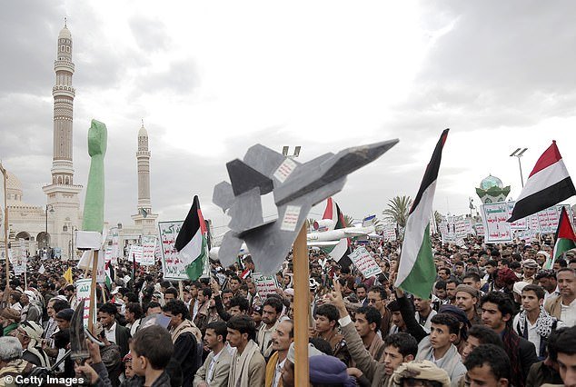Pictured: Yemeni Houthi supporters lift fake drones during a protest against the ongoing Israeli war in the Gaza Strip