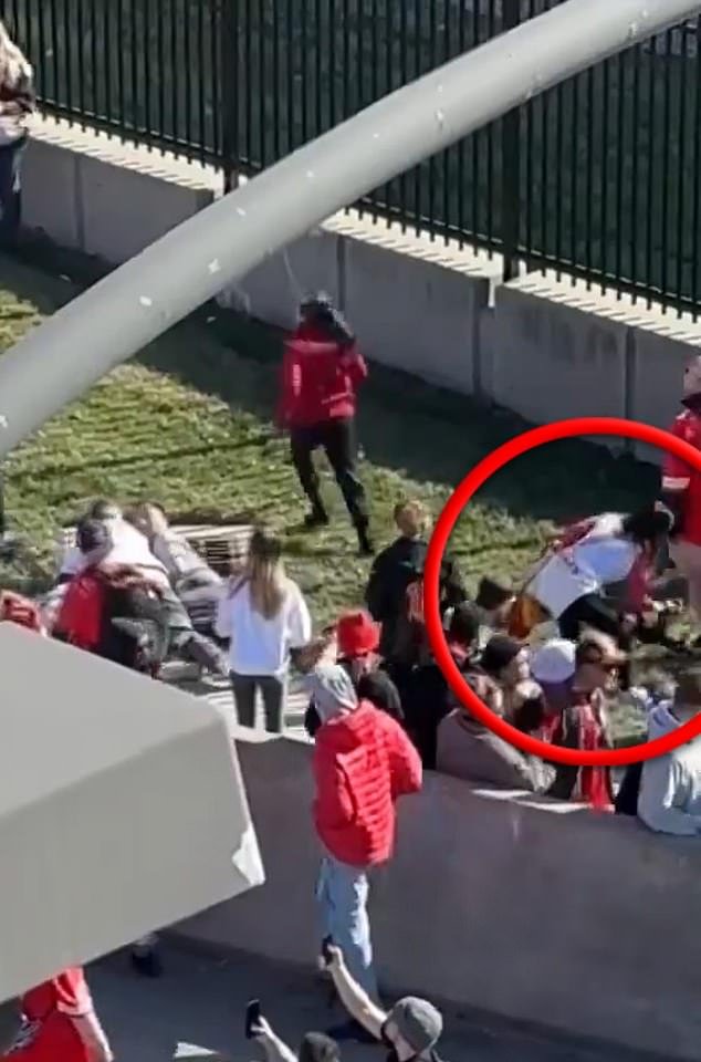 A woman, circled, is seen picking up the gun after fans tackled the suspected shooter