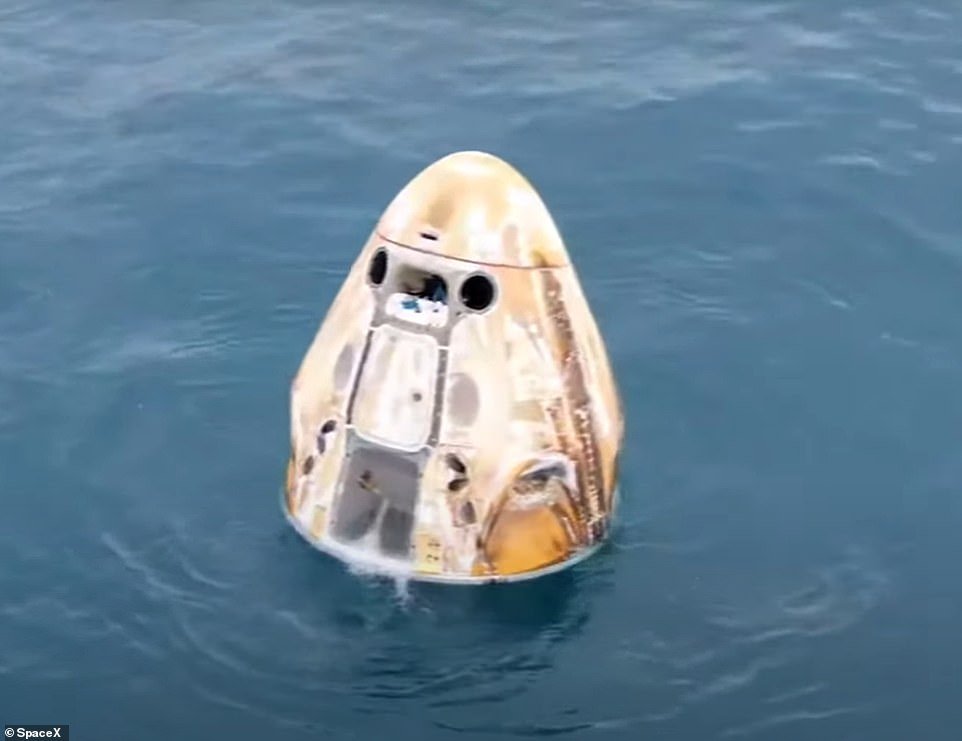 The SpaceX Dragon Crew capsule was floating in the Atlantic Ocean off the coast of Daytona, Florida, after it crashed.  The surface was scorched by the enormous heat generated during the reentry