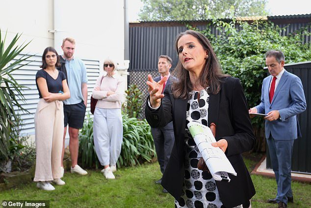 A tech entrepreneur has blamed Australia's cost of living for stifling Australian innovation, as people avoid startups to maintain secure jobs because a $200,000 salary can no longer buy a typical Sydney home (pictured an auction at Hurlstone Park)