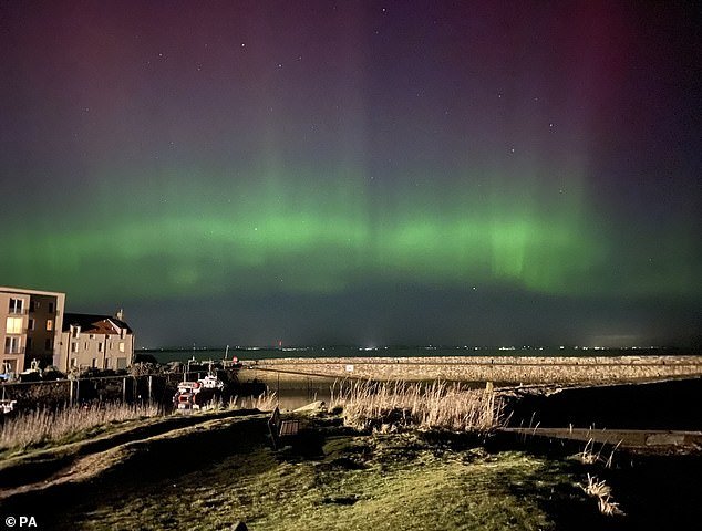 The Northern Lights seen over St Leonard's Head in St Andrews, Scotland, February 27, 2023