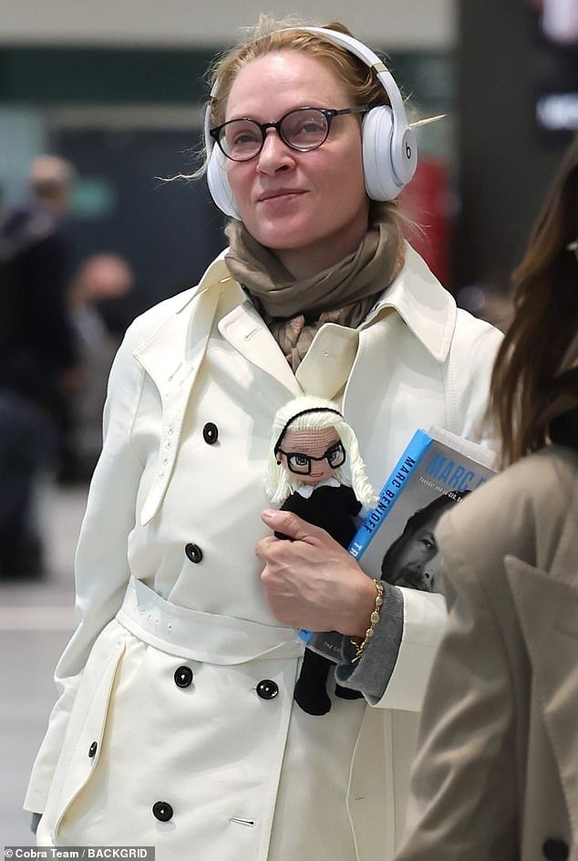 Upon arriving in Italy on Tuesday, Uma was spotted at the airport holding the same knitted doll