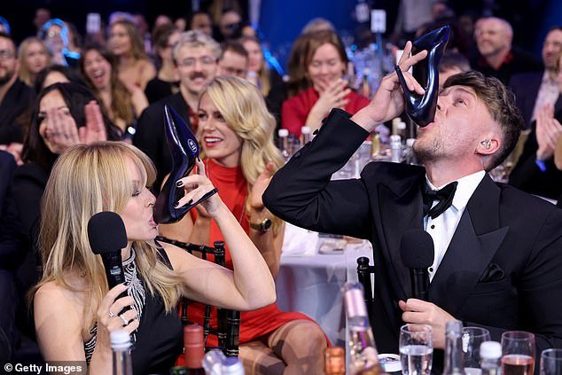Elsewhere during the chaotic ceremony, Roman convinced Global Icon Award winner Kylie Minogue to do a 'shoey' - an Australian tradition that involves drinking from a shoe.