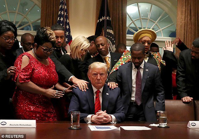 This real image shows the ex-president with African-American supporters, including Terrence Williams, Angela Stanton and Diamond and Silk, praying with Trump in the White House Cabinet Room in February 2020