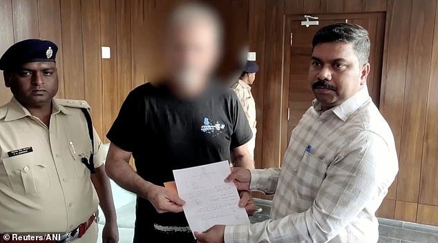 Authorities today presented a check for £9,500 to Vincente (centre) as compensation under a 'victim compensation scheme', broadcaster NDTV reported