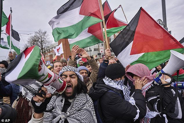 Protesters wave Palestinian flags and sing chants outside the Holocaust museum