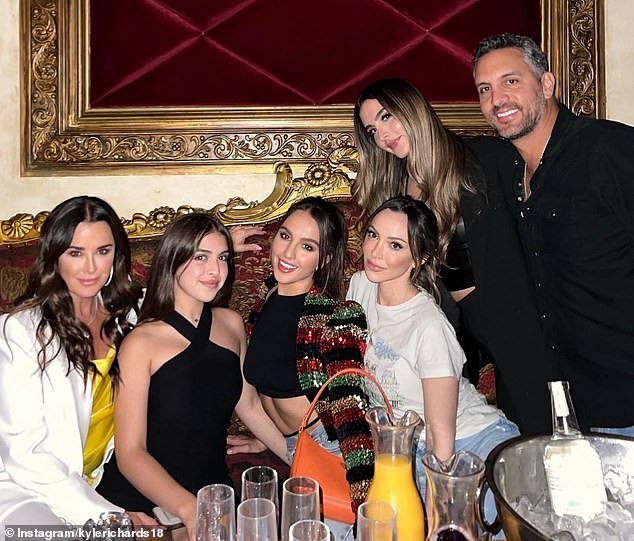 The duo are pictured with their three daughters Alexia, 27, Sophia, 24, and 16-year-old Portia, as well as Kyle's eldest daughter Farrah, 35