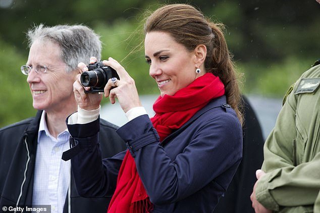 Catherine, then Duchess of Cambridge, takes photos as Prince William takes part in helicopter maneuvers over Dalvay Lake in 2011