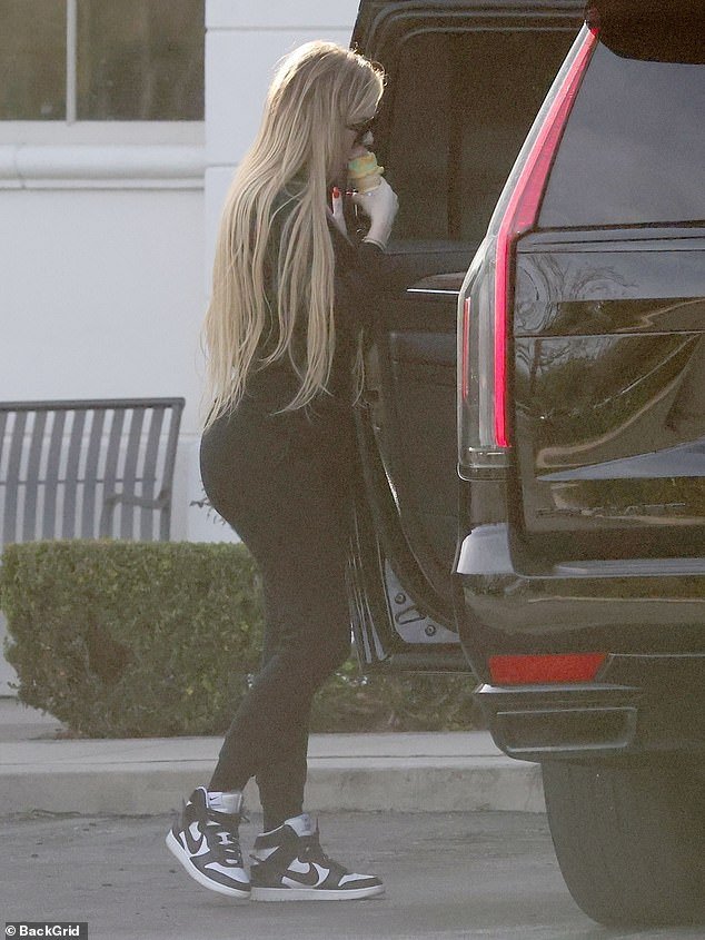 Khloe wore a long-sleeved top, skinny jeans and a pair of Nike sneakers