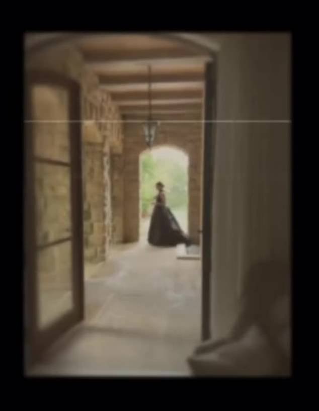 The video continues with an image of a woman in a long dress, illuminated by an Italian-style corridor leading outside.