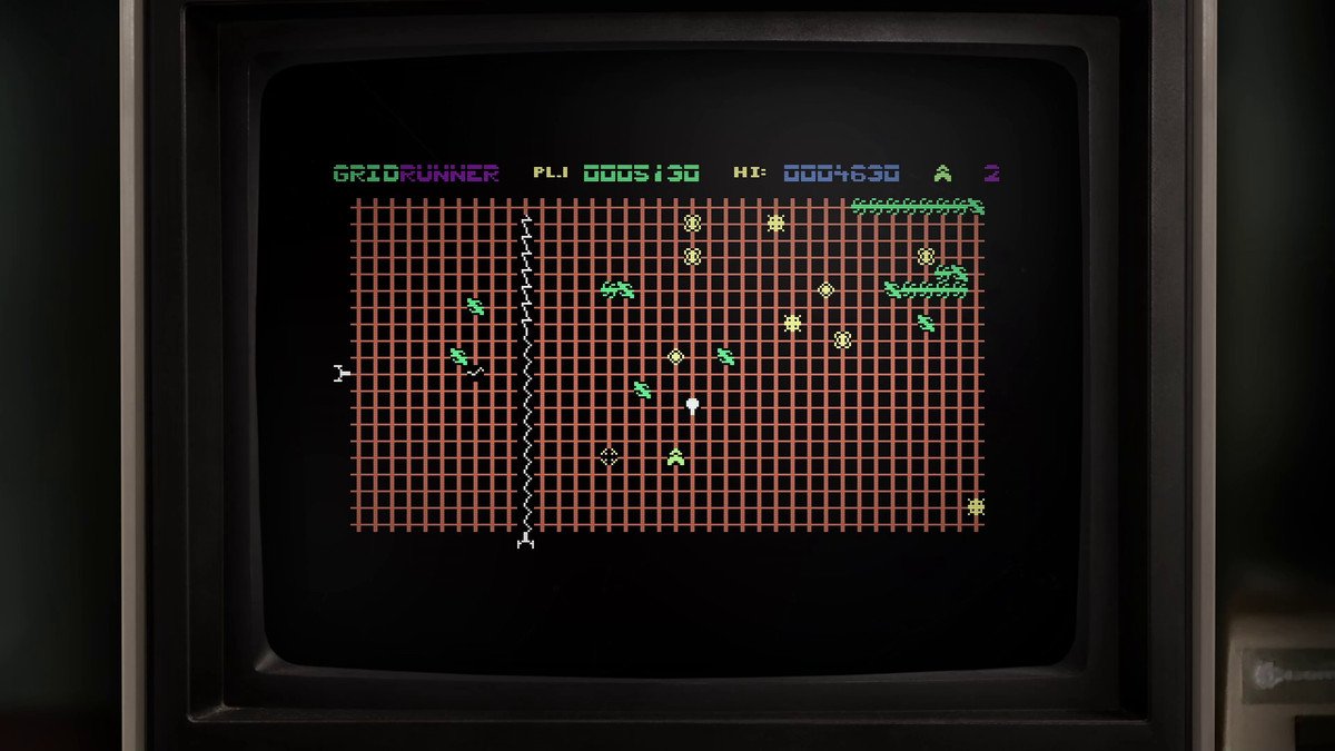 A screenshot of Gridrunner, framed by an old TV monitor, showing the simple 8-bit graphics