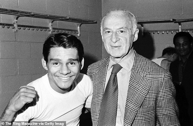 Duran celebrates with trainer Ray Arcel in the locker room after the win over Ken Buchanan