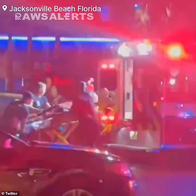 One of the three injured people was loaded into the back of an ambulance in downtown Jacksonville Beach on Sunday