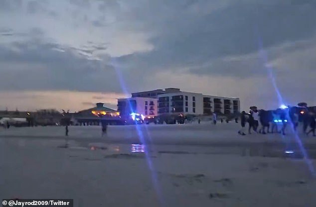The blue lights of police cars could be seen from the beach at Jacksonville Beach